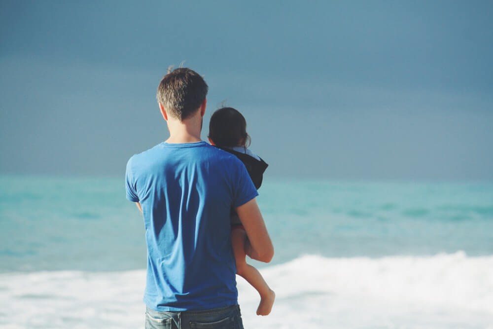 Ways to Prepare for Foster Care: man and toddler looking out to sea on a sunny day