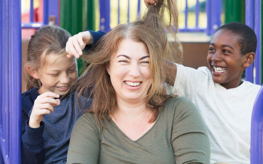 Foster parent with two foster happy foster children